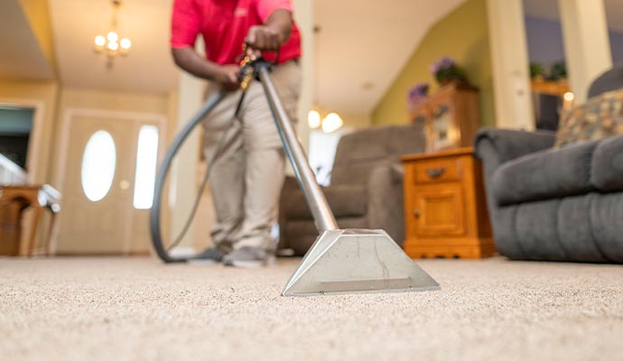 worker cleaning carpet
