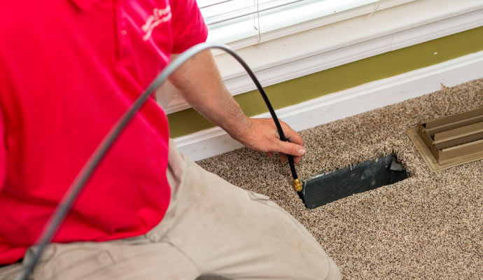 Professional worker cleaning duct