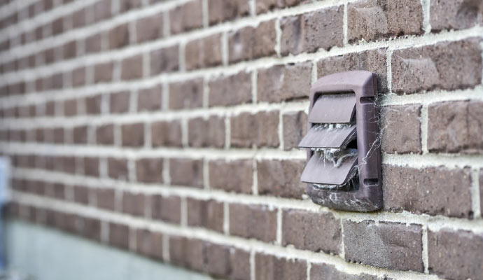 Exterior wall vent mounted on a brick wall