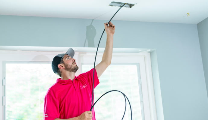 Professional worker cleaning duct