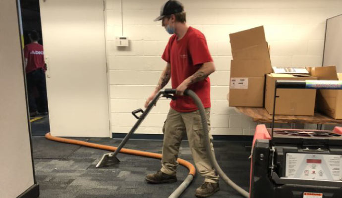 professional worker cleaning carpet in s commercial space