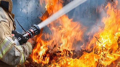 Firefighter extinguishing fire