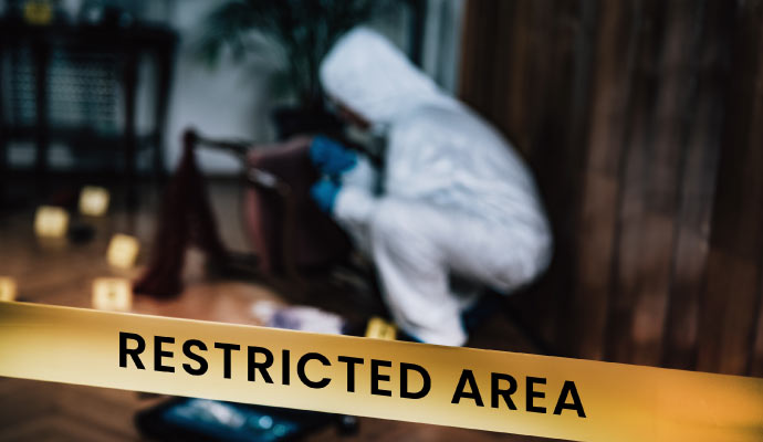 Restricted area sign with yellow caution tape at a bio-hazardous area.