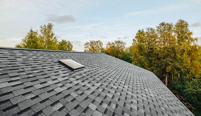 a well maintained house roof covered with grey shingles